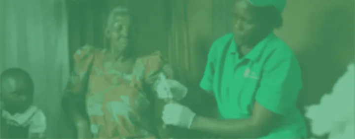 A community health worker assisting a patient